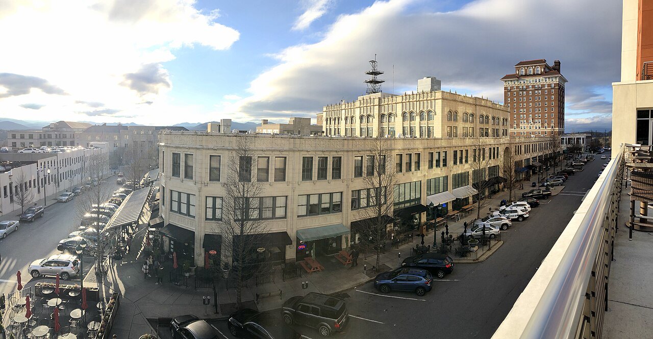 The Grove Arcade building and the Battery Park Hotel above a downtown Asheville street.