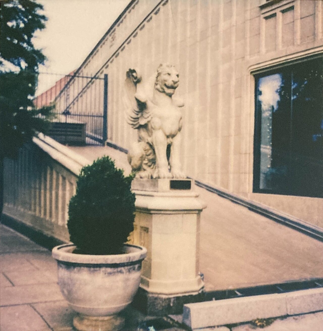 A carved gryphon beside the steps of the Grove Arcade in Asheville.