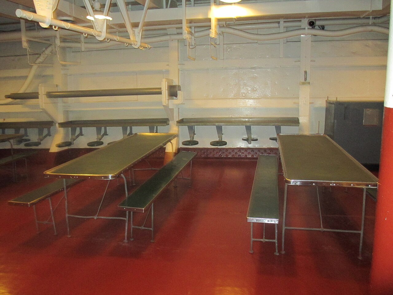 A mess hall with long tables below decks on the Battleship North Carolina.