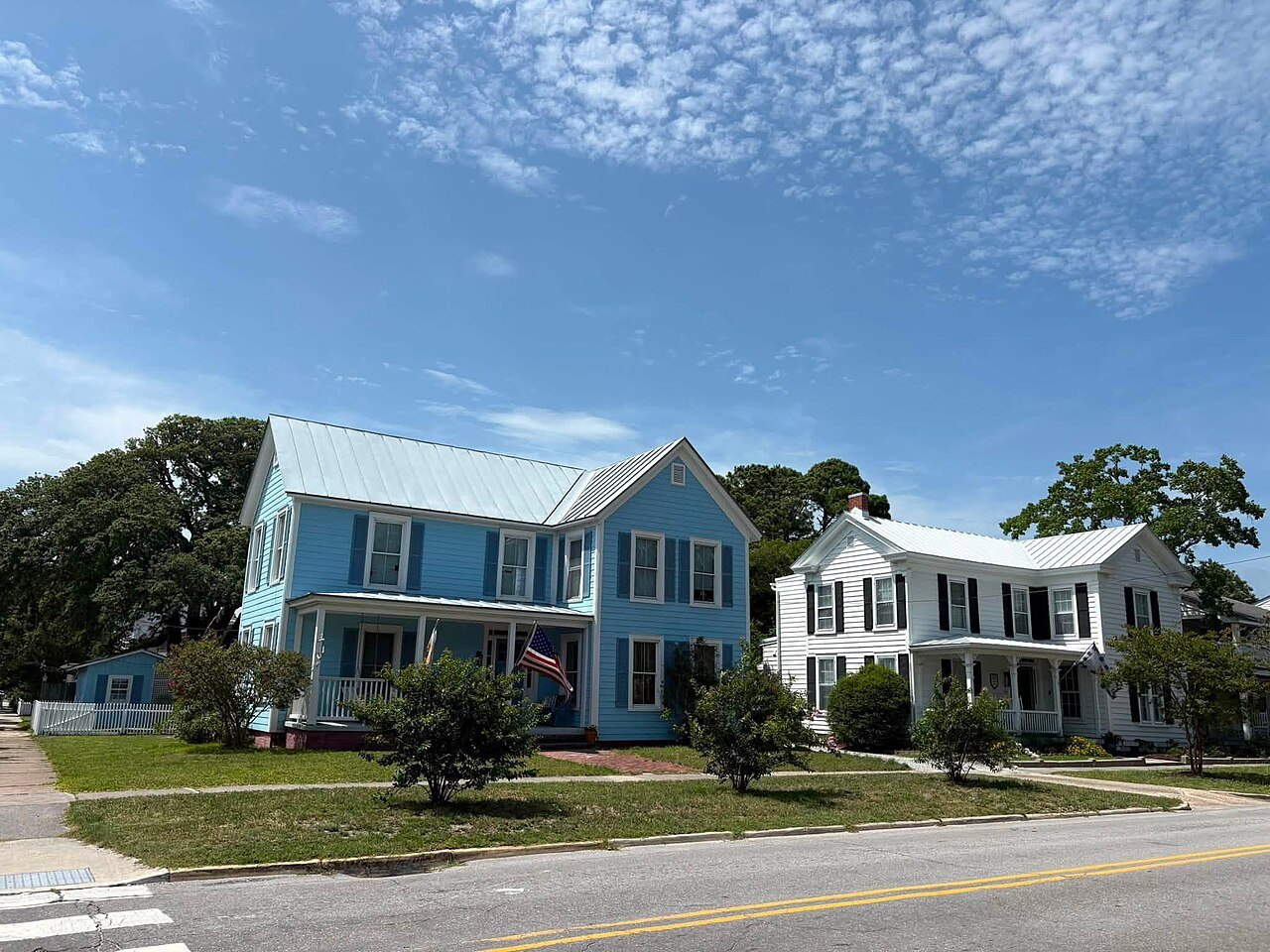 Painted houses on a wide, quiet street in Beaufort.
