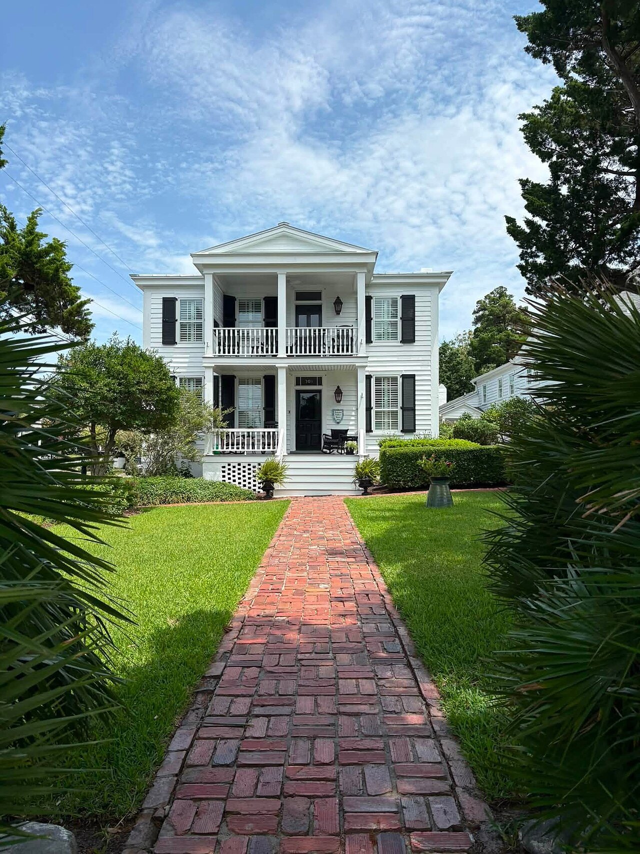 A brick walk between palms to a white mansion in downtown Beaufort.