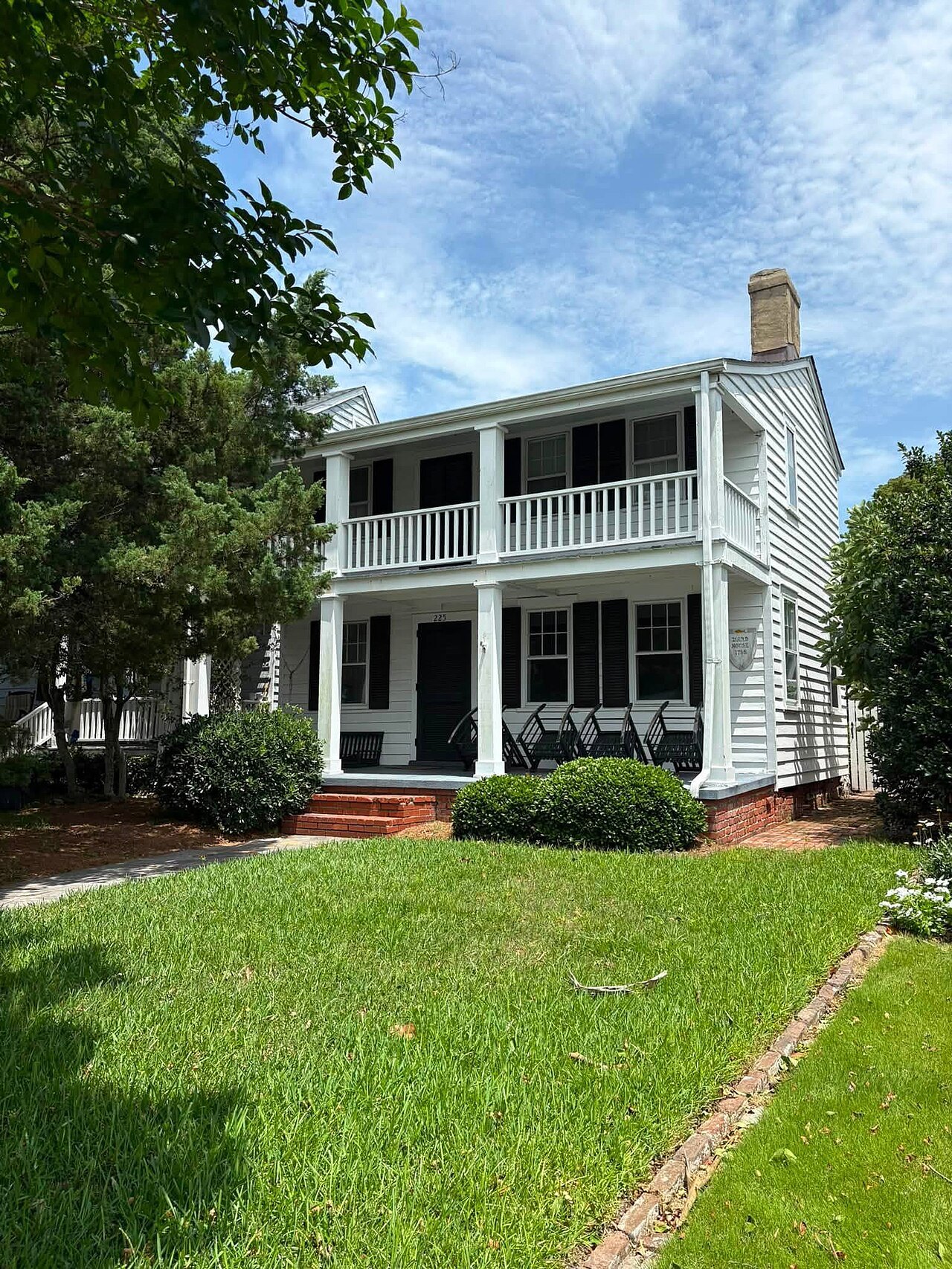 A white house with two tiers of porches on Front Street, Beaufort.