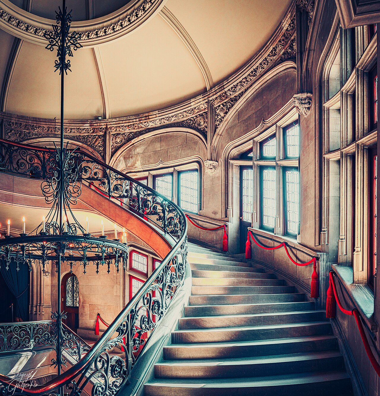 The grand spiral staircase and chandelier inside Biltmore House.