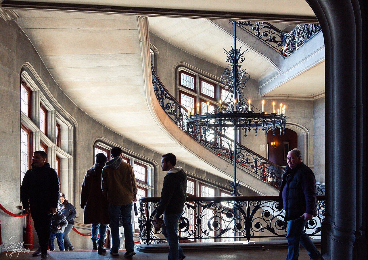 Visitors on the landing beside the sweeping stair at Biltmore House.