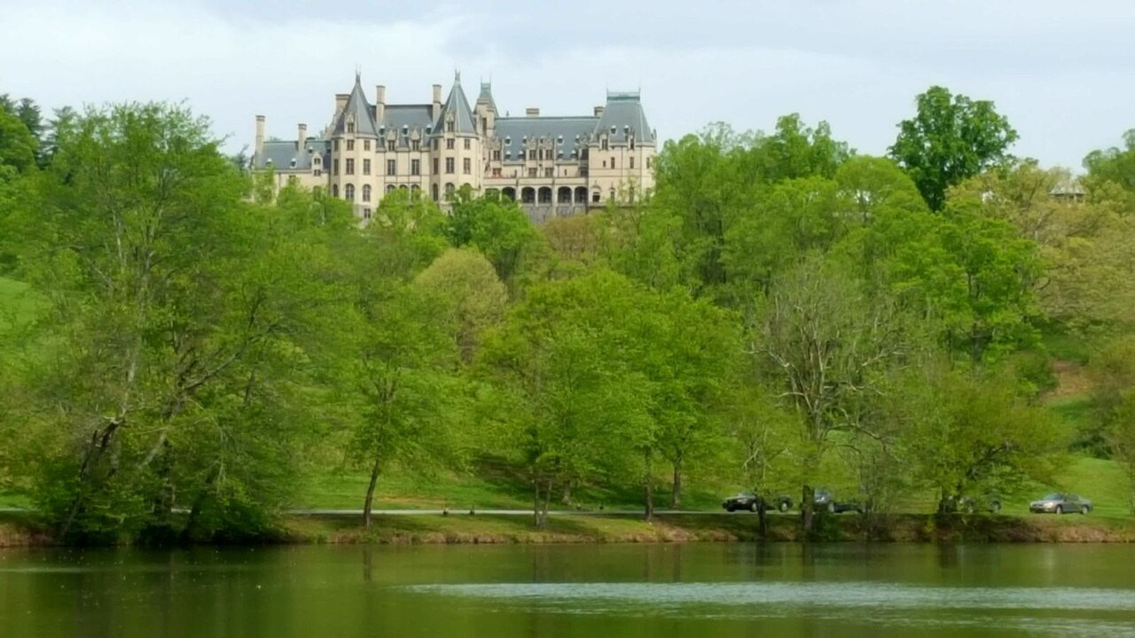 Biltmore House seen across the Lagoon, high on its hill above the trees.