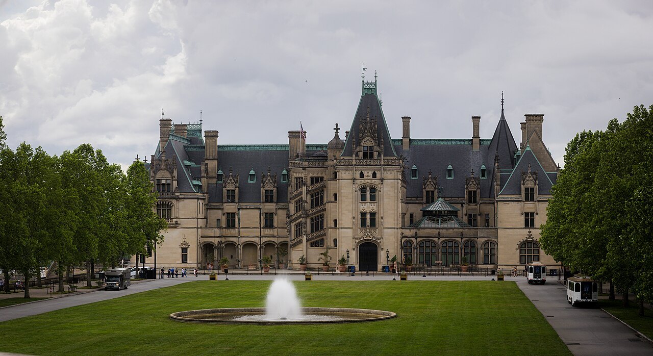 The long front of Biltmore House seen across its lawn and fountain.