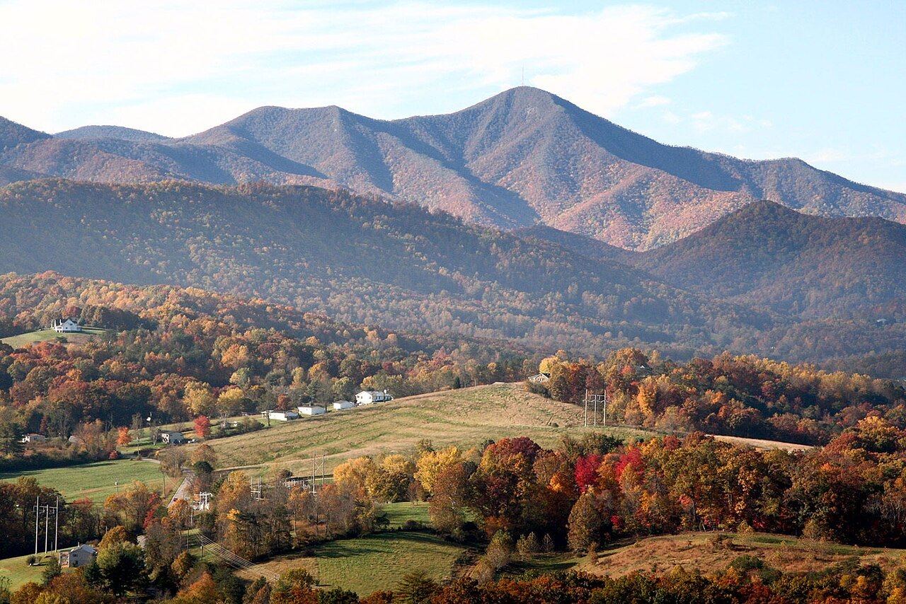 Mount Pisgah above autumn woods and fields.