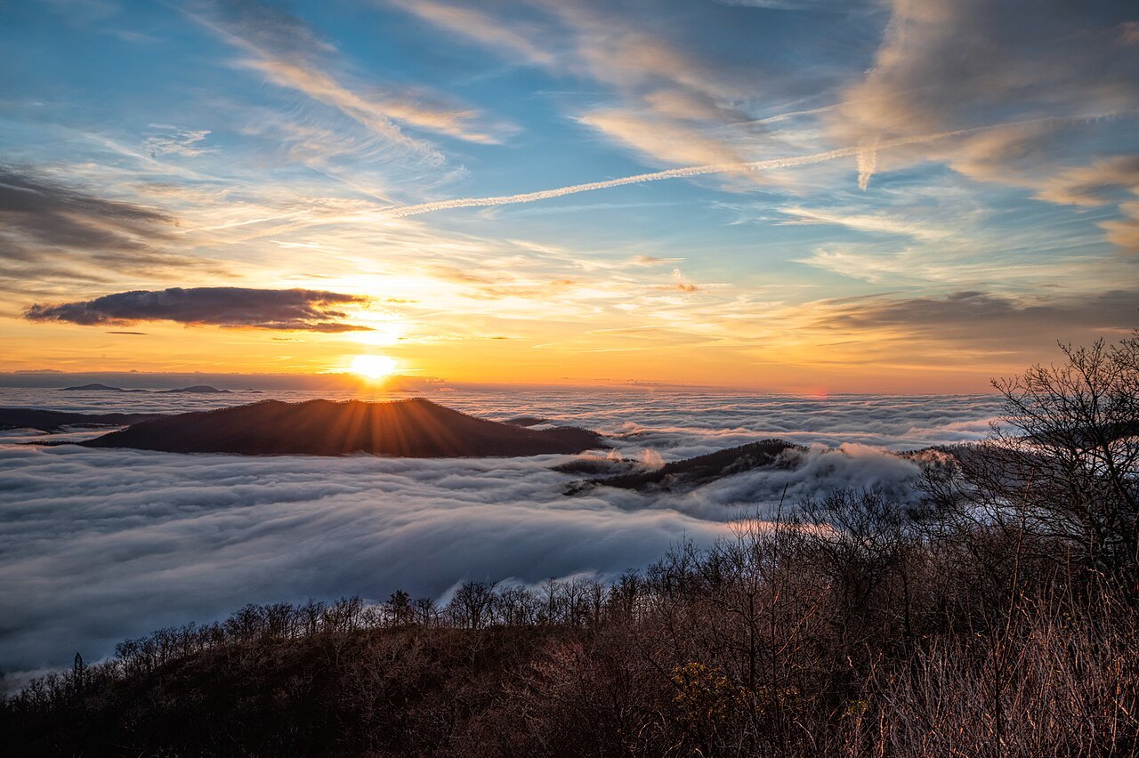 Sunrise over a sea of cloud filling the valleys below the Parkway.