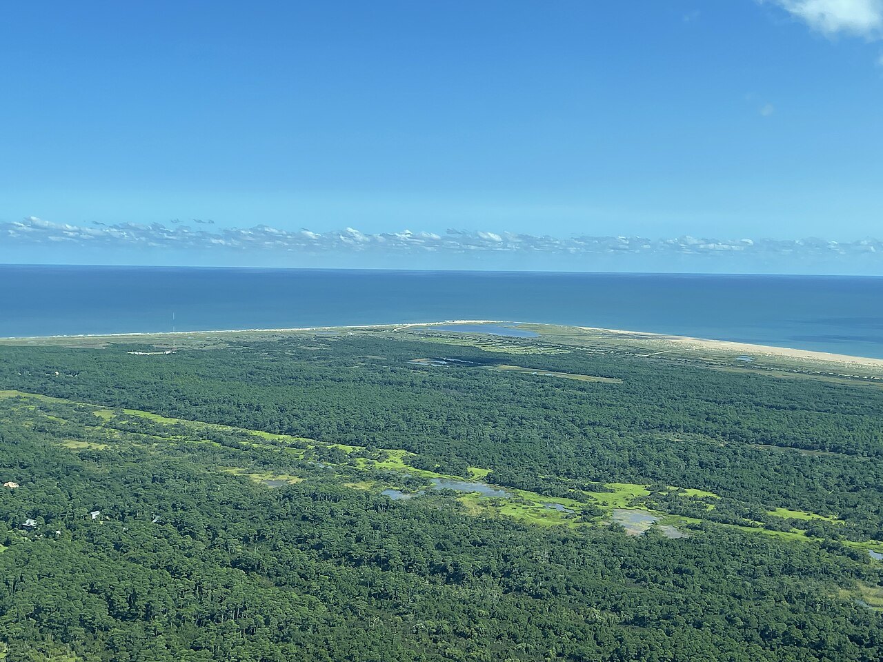 The Outer Banks from the air, with the forest of Buxton Woods and the sea toward Cape Point.