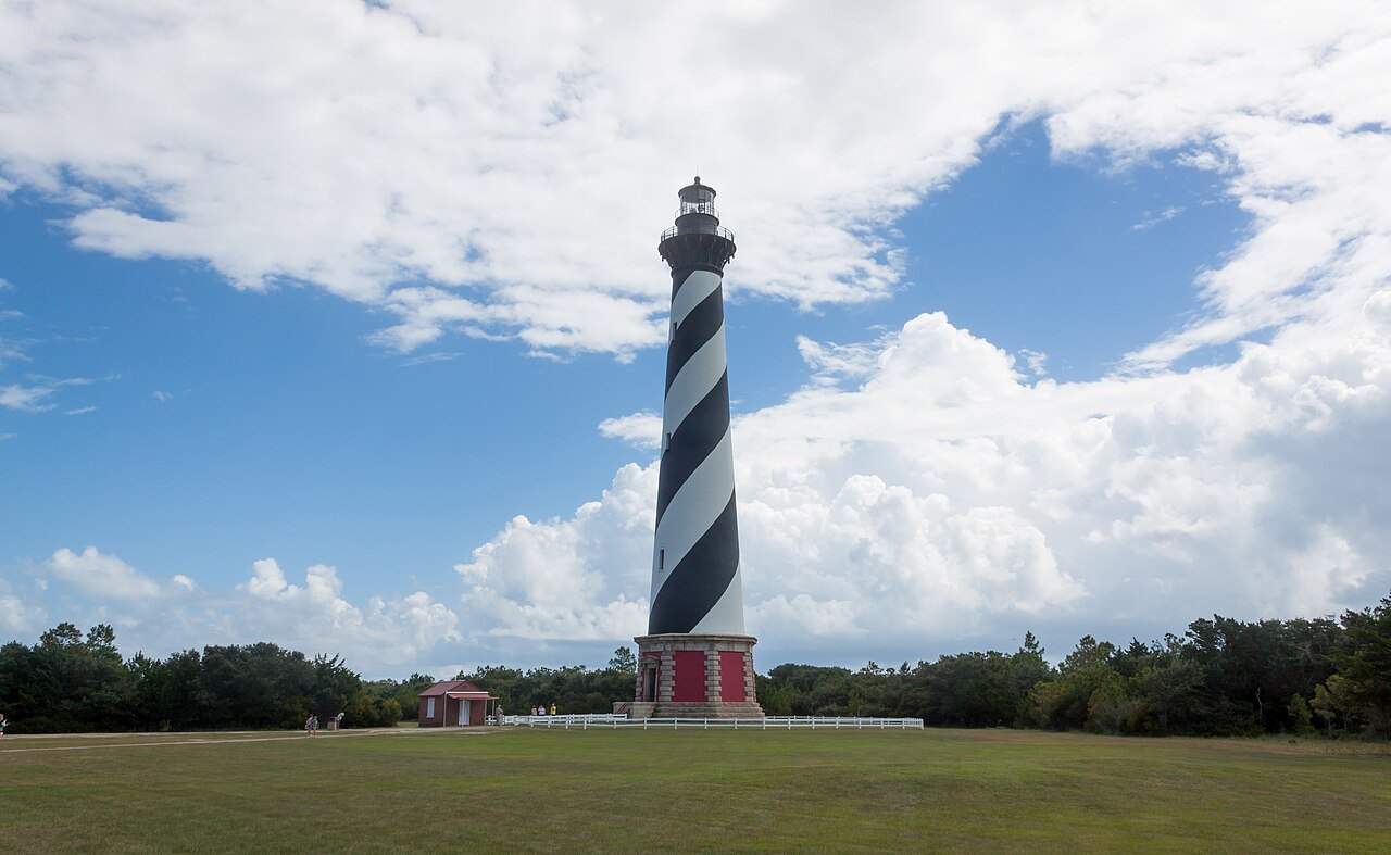 The Cape Hatteras Lighthouse above the grass of its site.
