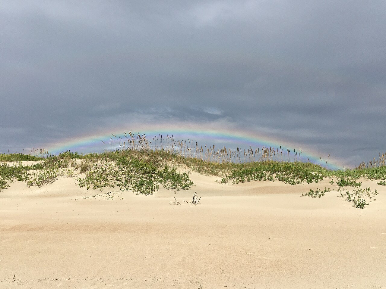 A faint rainbow over a dune on the Outer Banks.