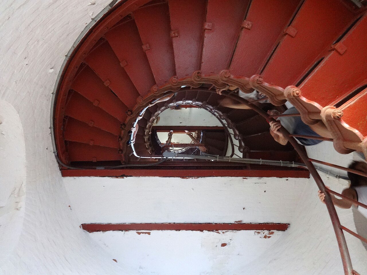 Looking up the red iron spiral stair inside the Cape Hatteras Lighthouse.