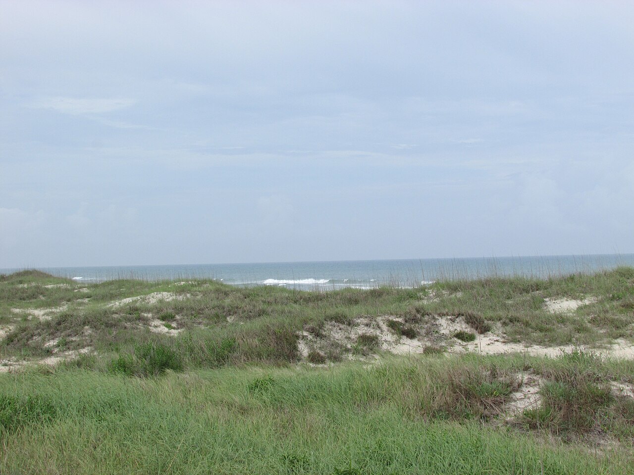 Dunes and grass on the Core Banks, with the Atlantic beyond.