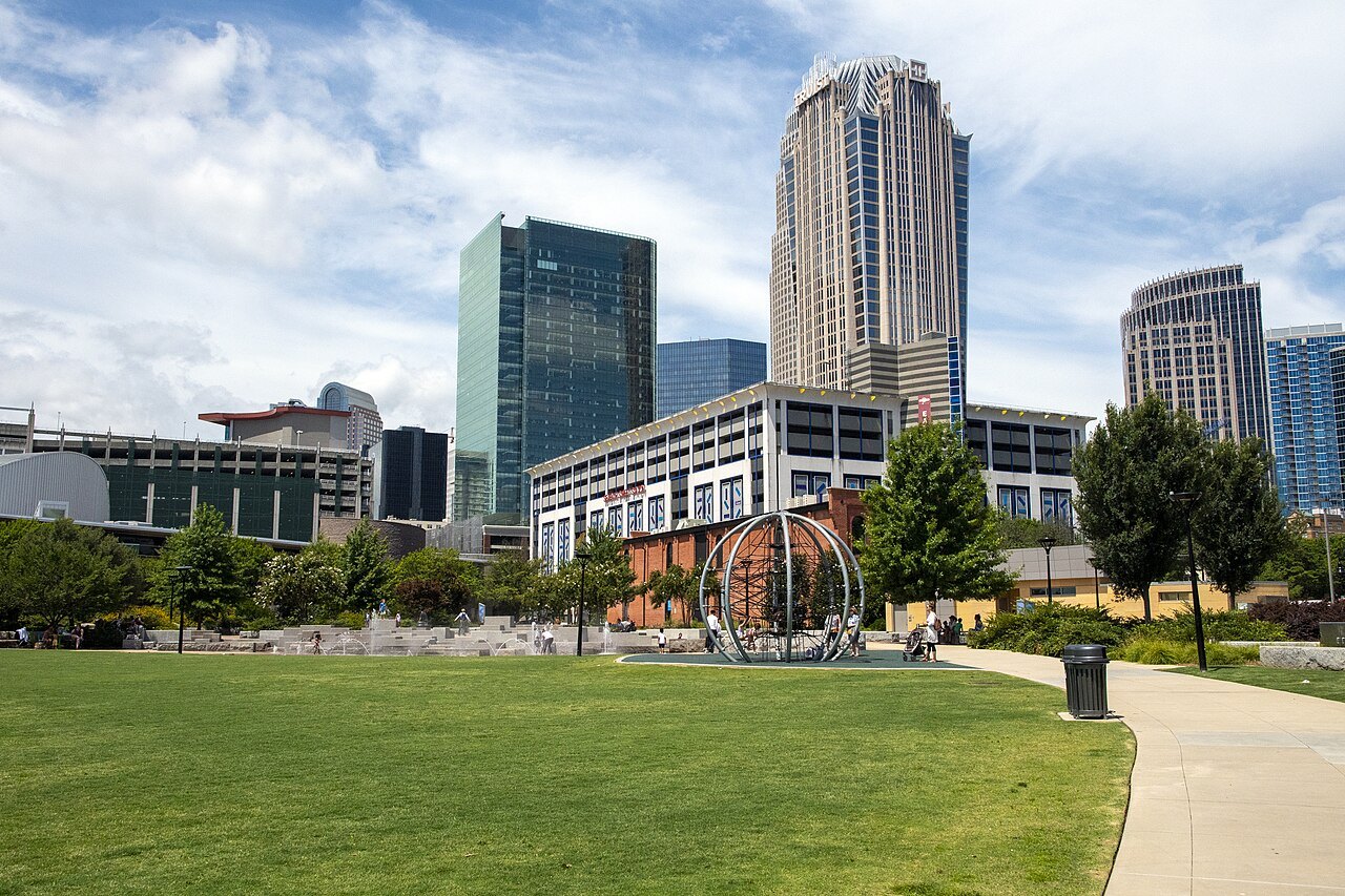 Uptown Charlotte's towers above the lawns of a city park.