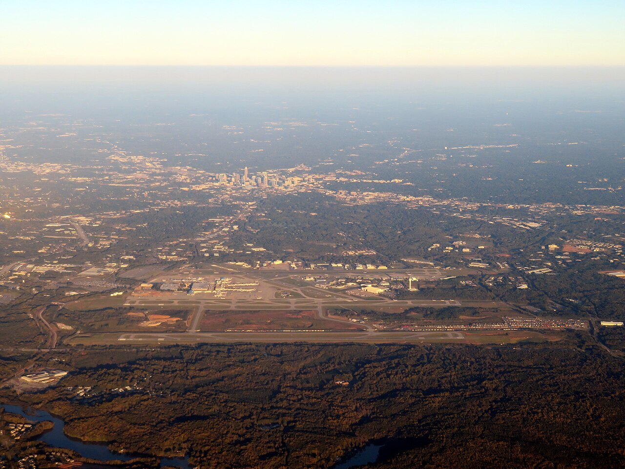 Charlotte's airport and downtown seen from the air at sunset.