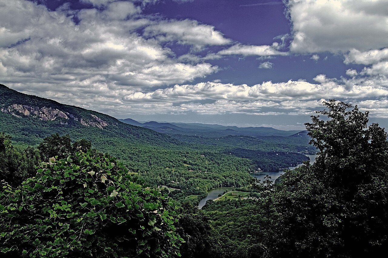 Hickory Nut Gorge and its cliffs under big clouds.