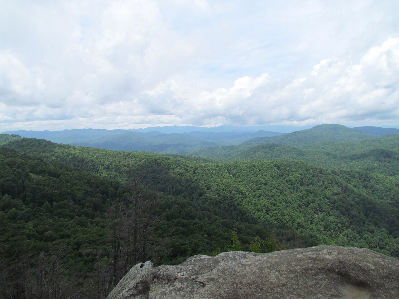 Forested ridges rolling away from Eagle Rock in Chimney Rock State Park.
