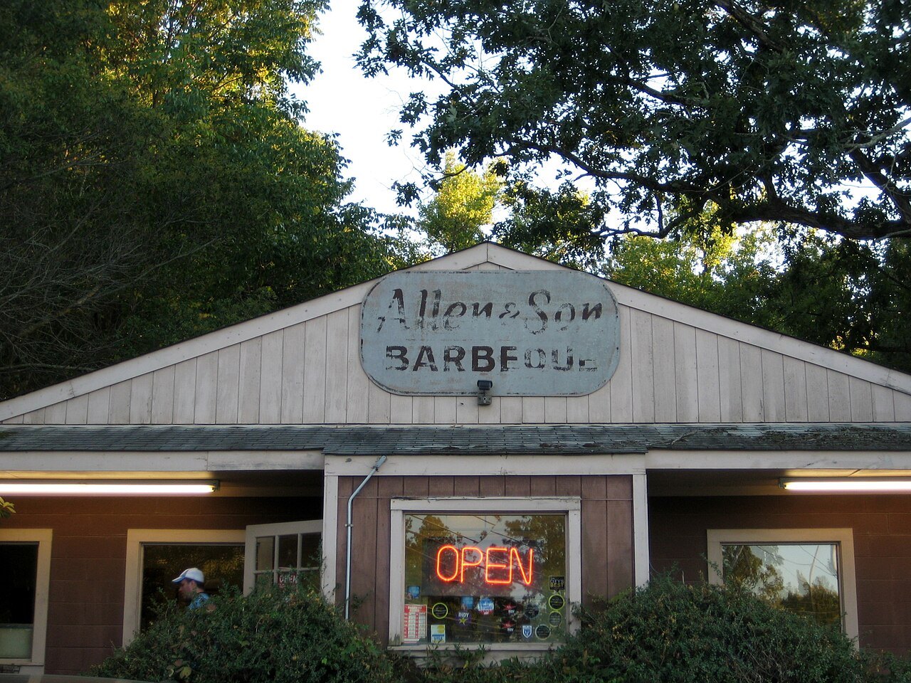 The front of Allen and Son Barbecue, with its open sign lit.