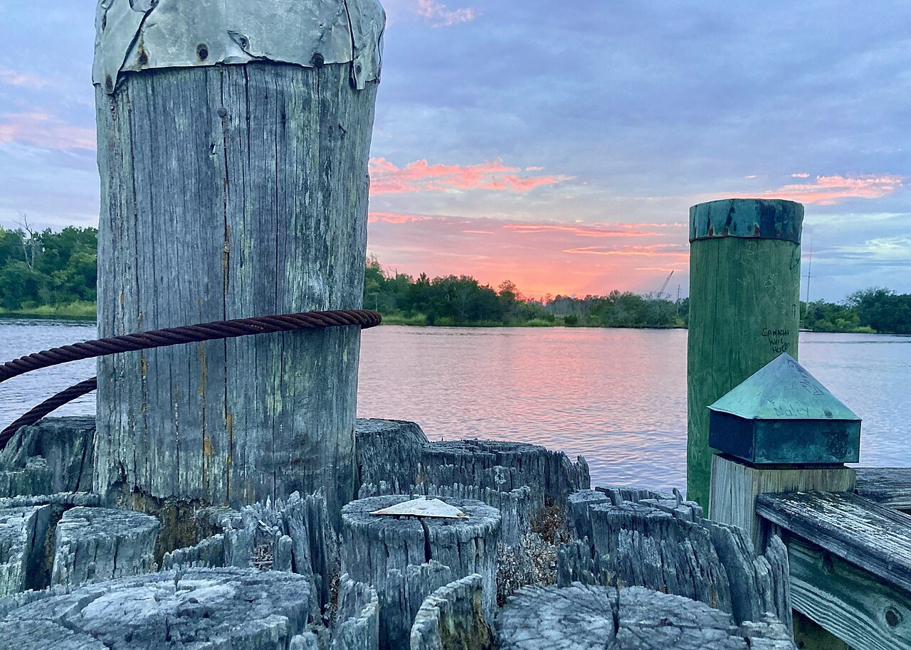 Old dock pilings at sunset on the Cape Fear River in downtown Wilmington.