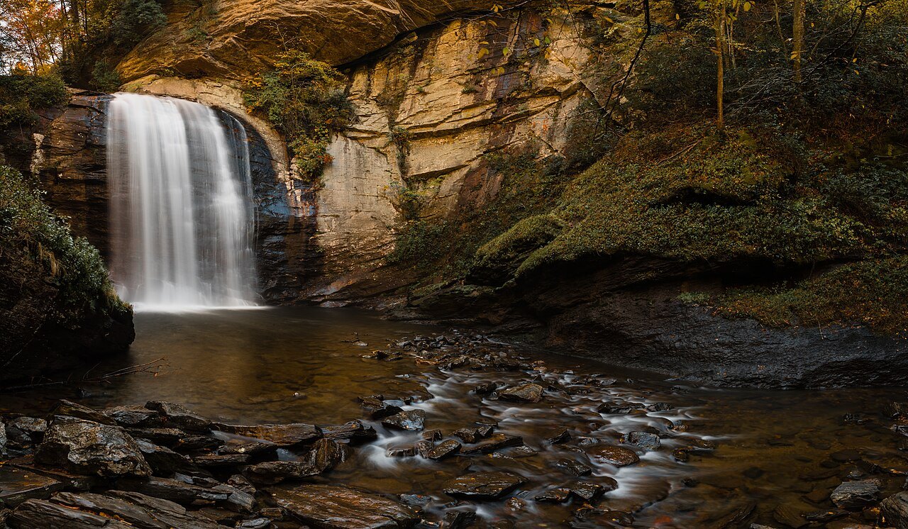 Looking Glass Falls pouring into its pool in autumn.
