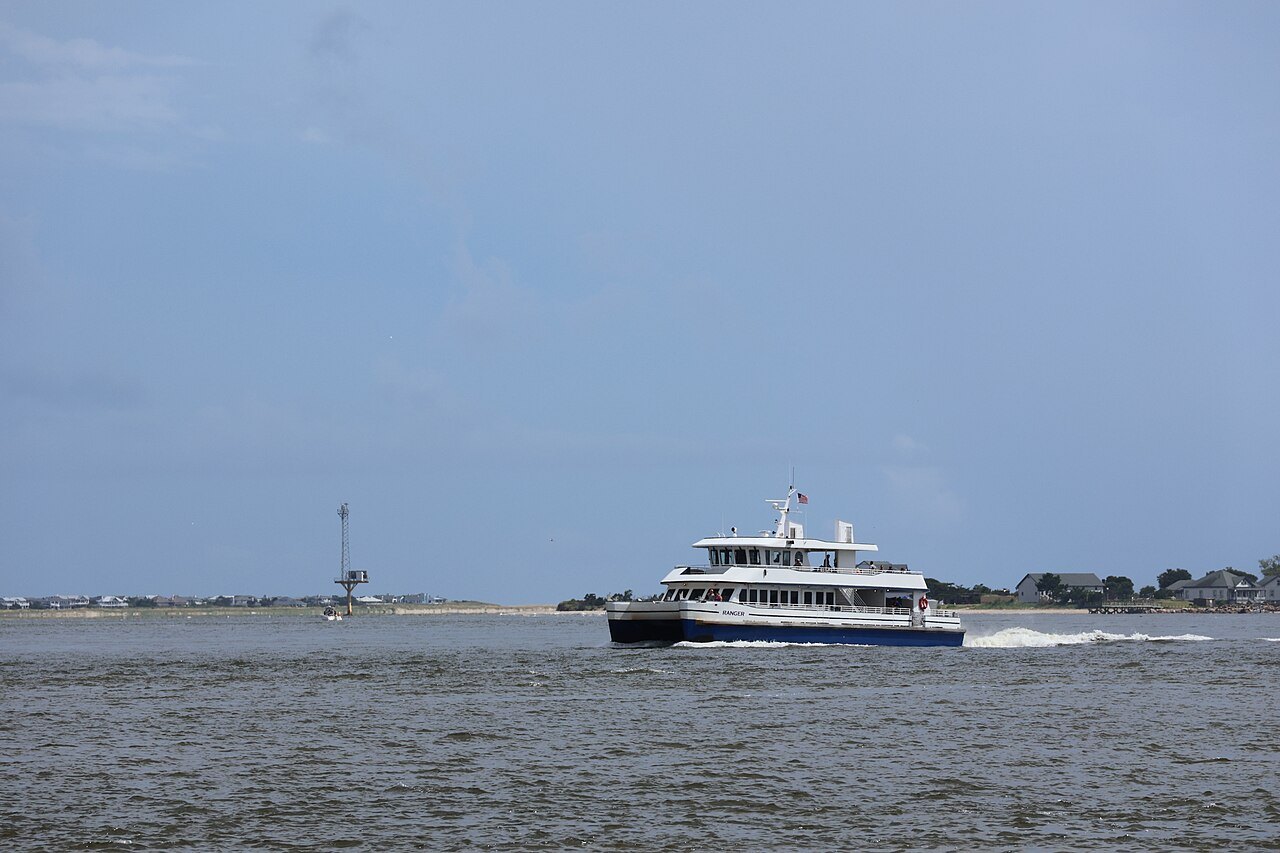 A ferry crossing toward Bald Head Island at the mouth of the Cape Fear.