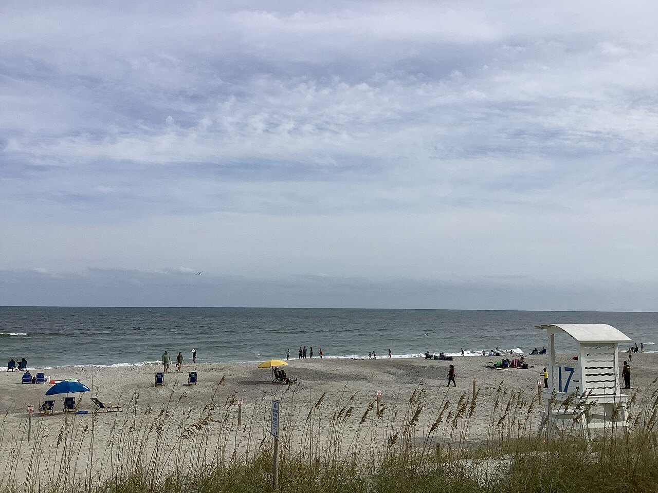 Beachgoers and a lifeguard stand at Carolina Beach in October.