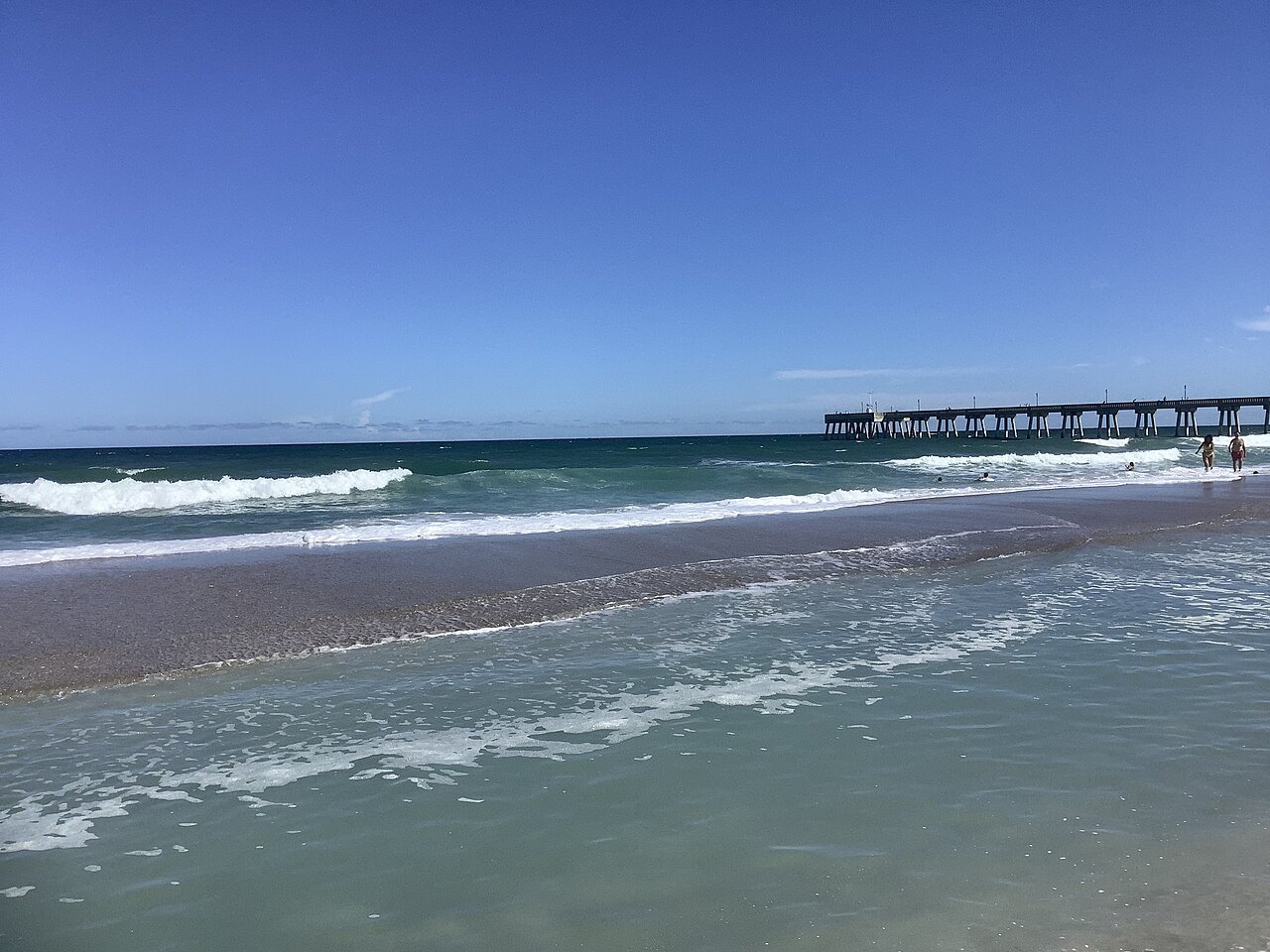 Waves breaking below a fishing pier at Wrightsville Beach.