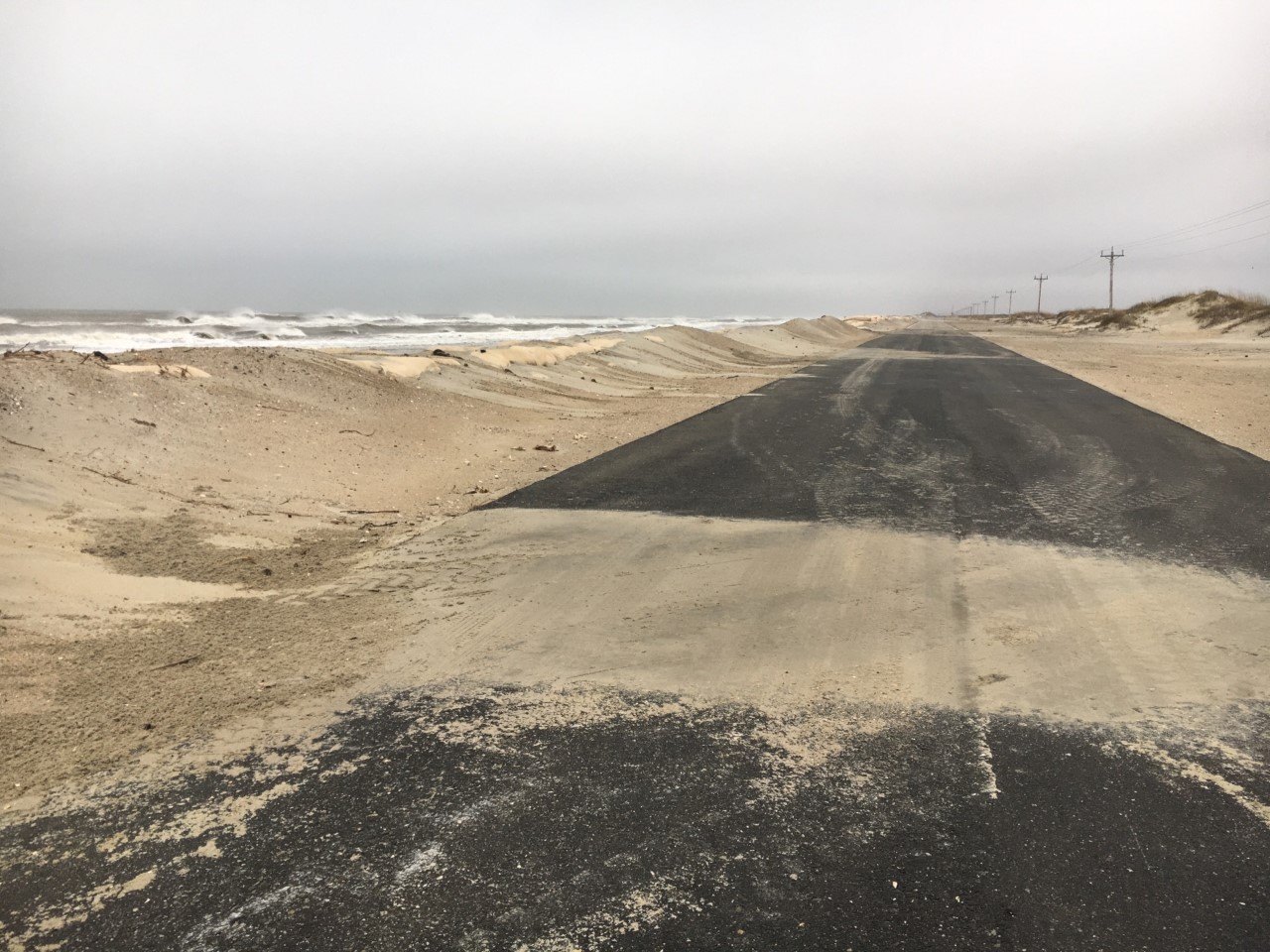 Sand drifted across NC 12 at the north end of Ocracoke Island.