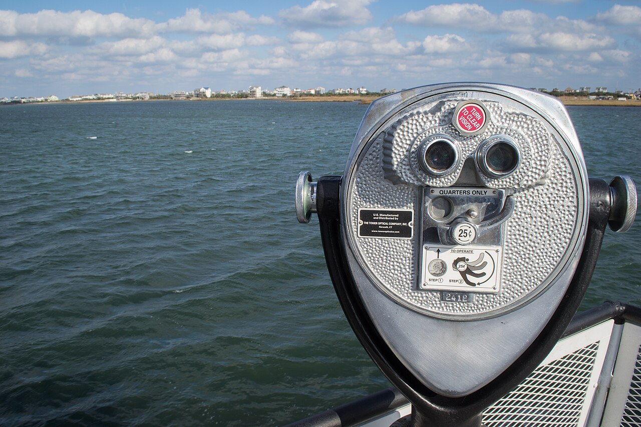 A coin telescope at the rail of a ferry leaving Rodanthe.