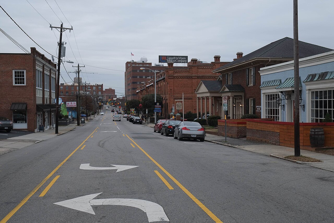 A downtown main street of low brick buildings.