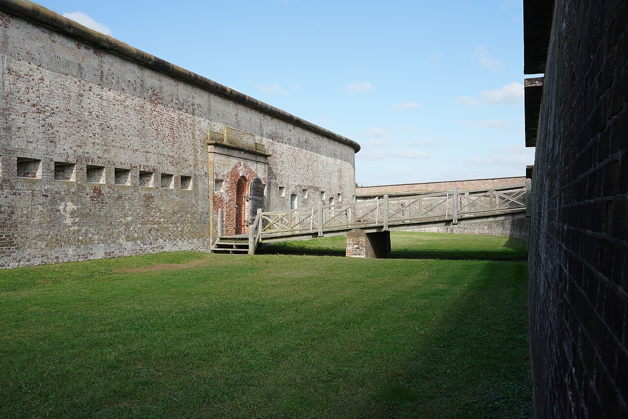 The walls of Fort Macon rising above the grass of its ditch.