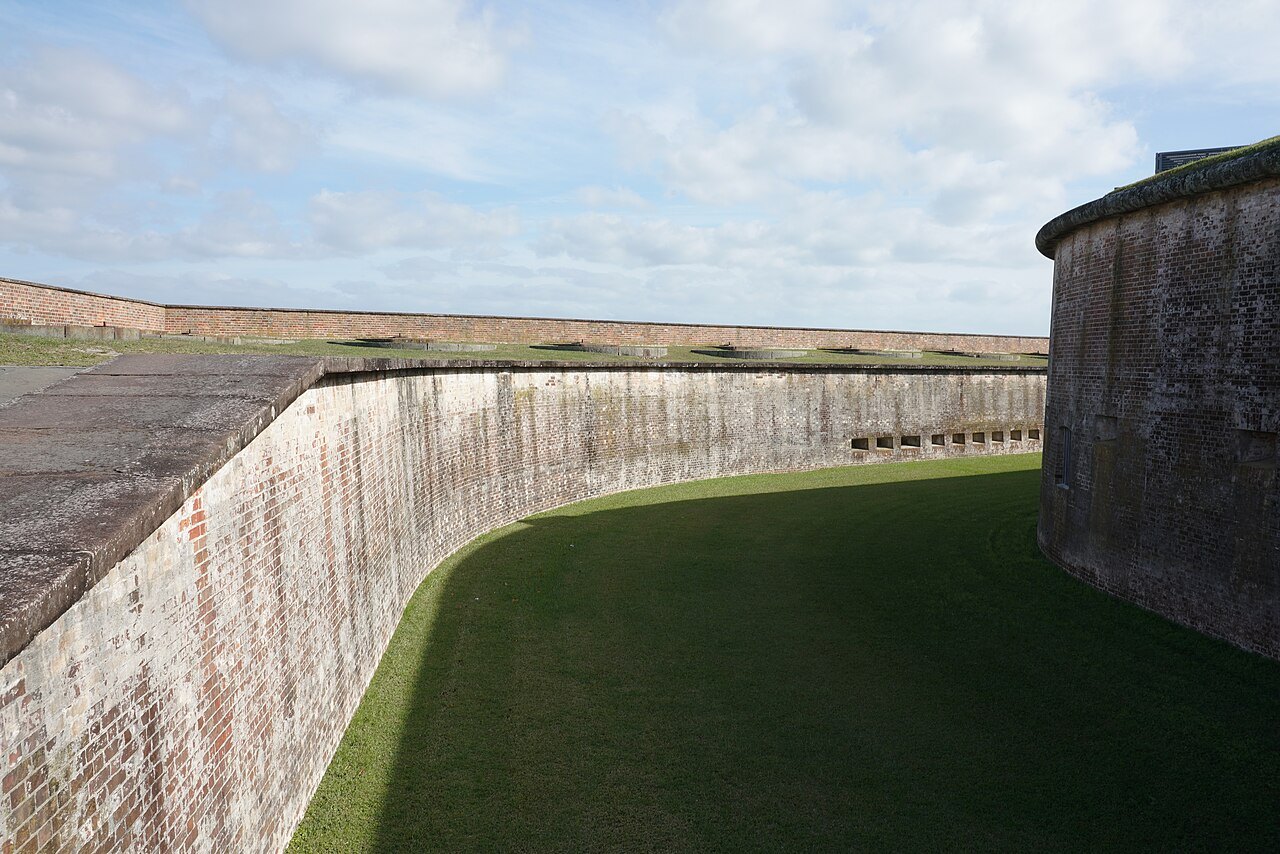The inner walls of Fort Macon curving around the ditch.