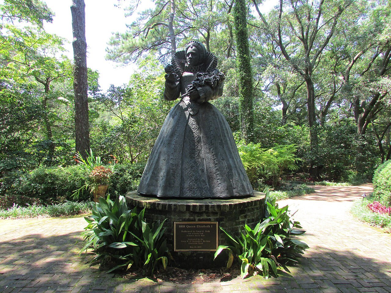 A statue of Queen Elizabeth I among the trees of the Elizabethan Gardens.