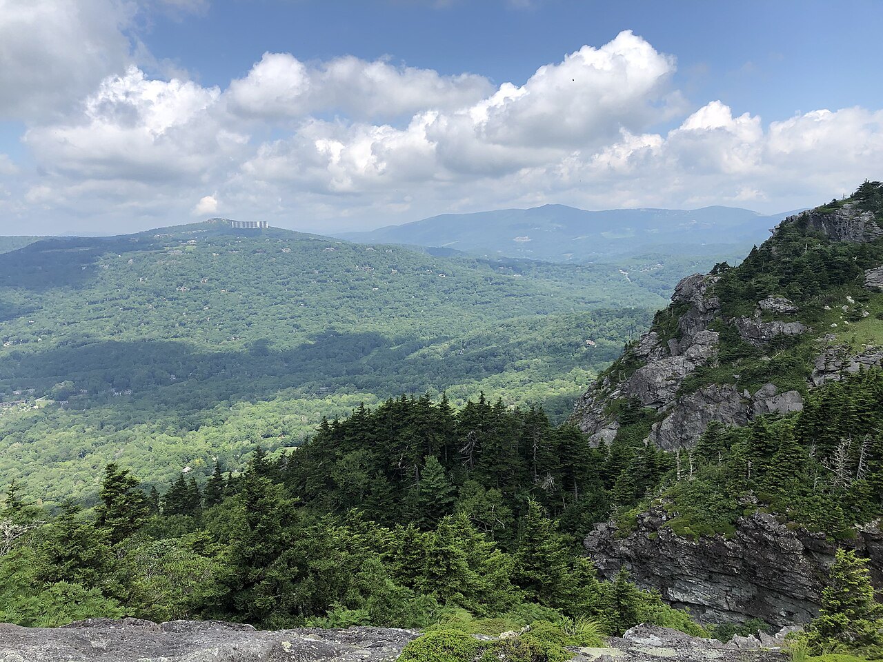 Forested valleys below the rocky flank of Grandfather Mountain.
