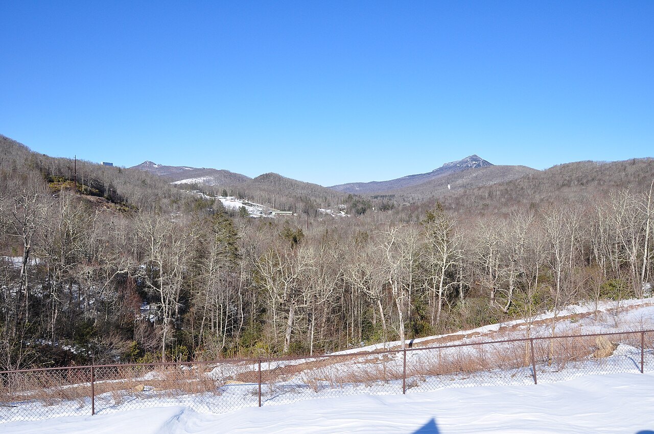 Winter snow in the hills north of Linville, with bare hardwoods below the ridgeline.