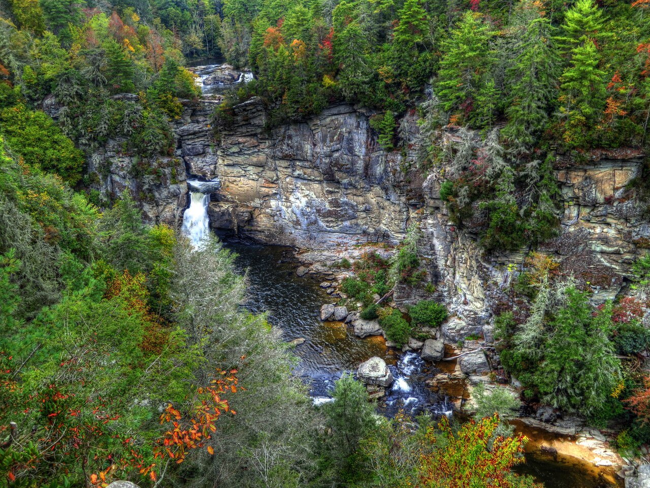 The lower falls pouring into the rocky gorge in autumn.