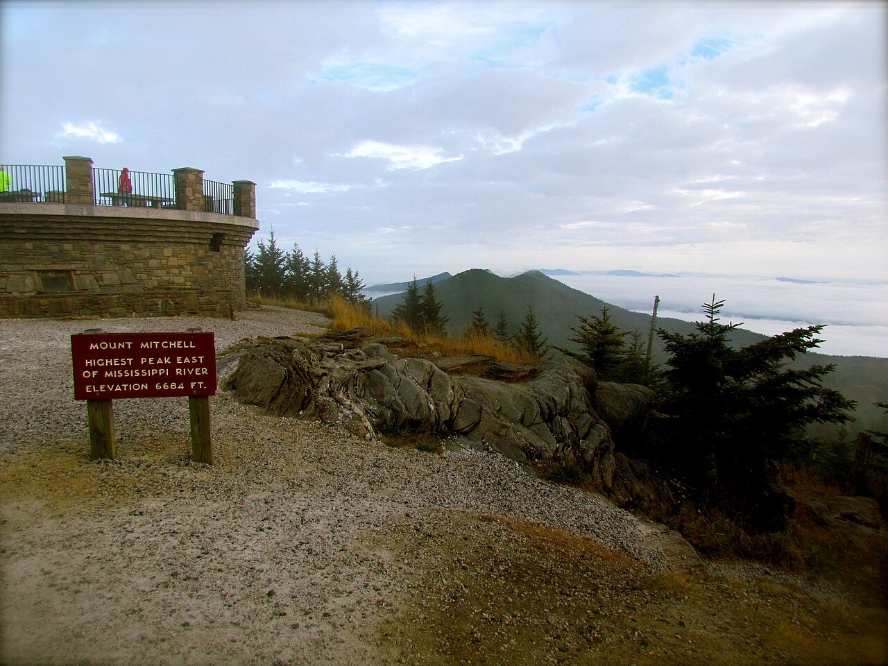 The sign marking the summit of Mount Mitchell, with the Black Mountains beyond.