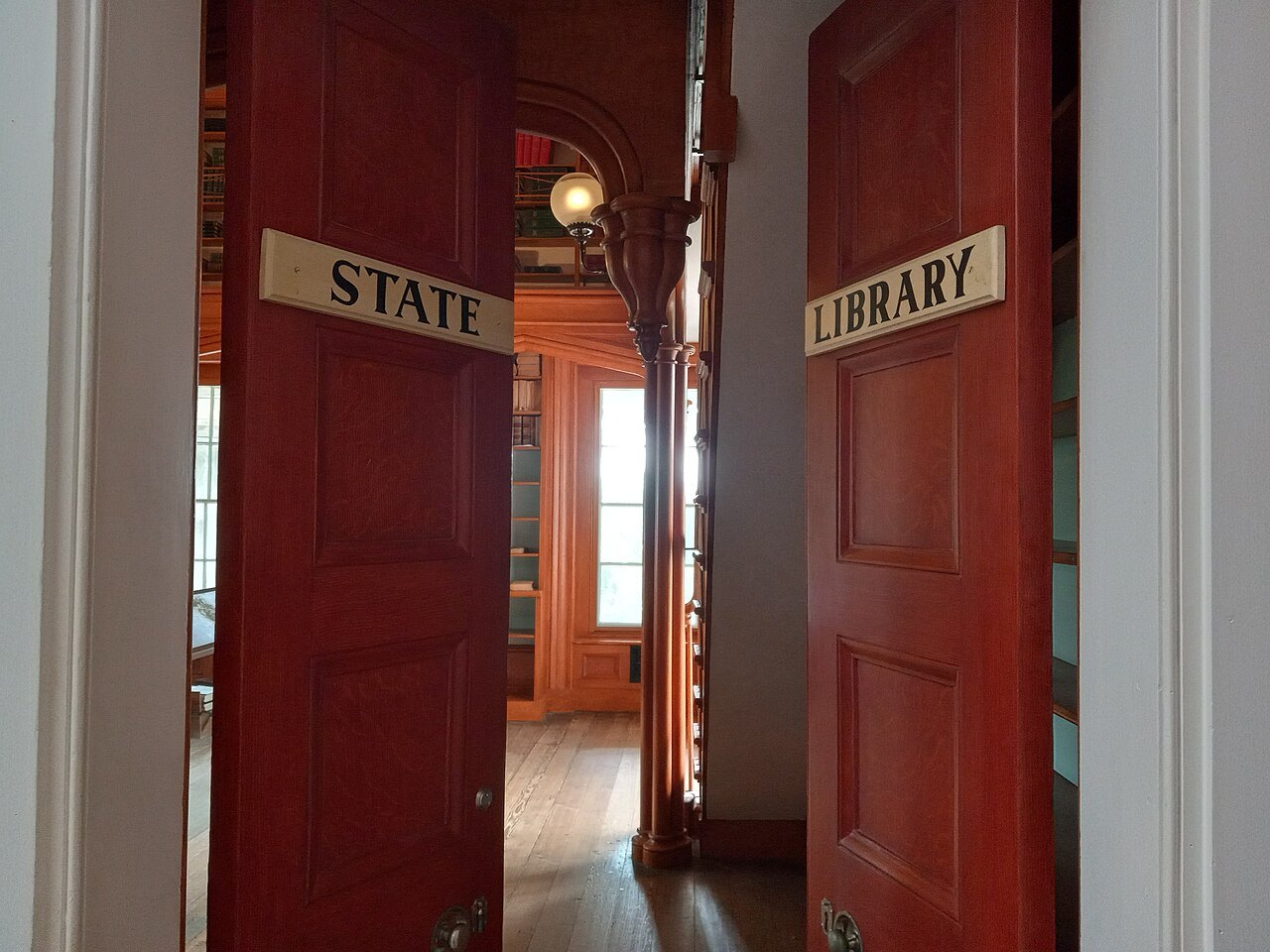 Doors marked State Library inside the North Carolina State Capitol.