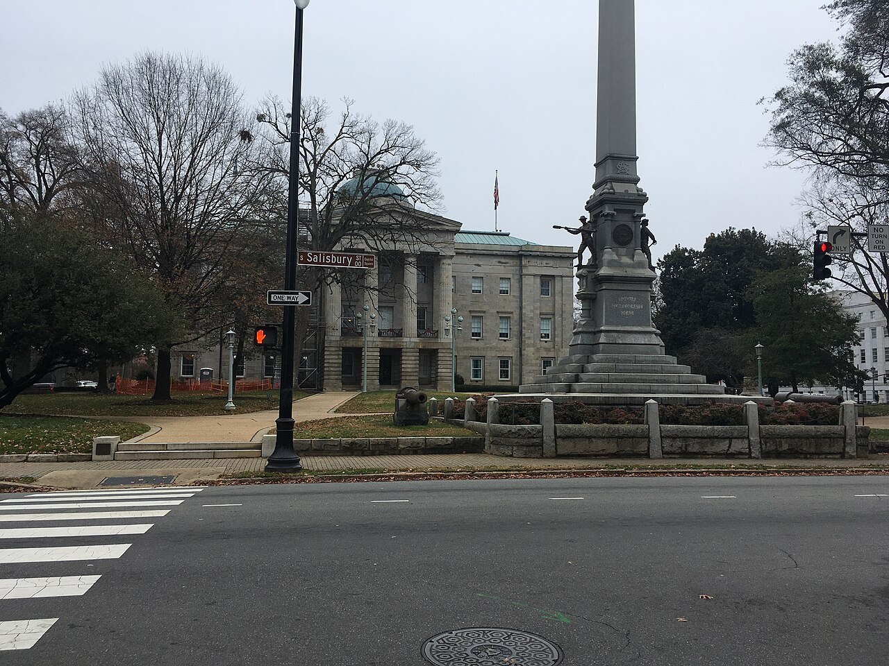 The State Capitol and a tall monument seen from Fayetteville Street.