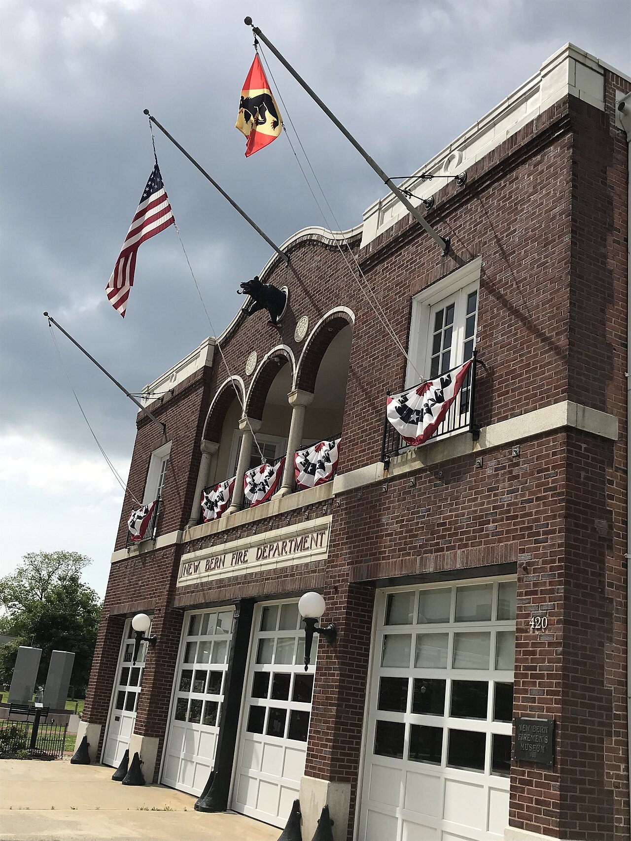 The brick front of the New Bern Firemen's Museum, hung with bunting.