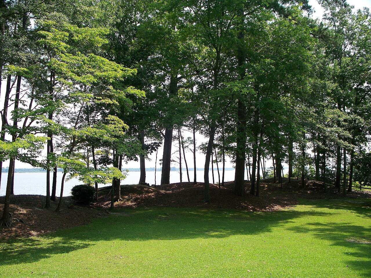 Lawn and pines above the Neuse River at the Fort Thompson site in New Bern.
