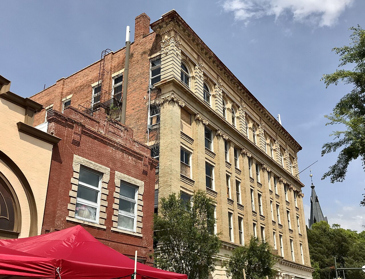The Elks Building rising above an older brick front in New Bern.