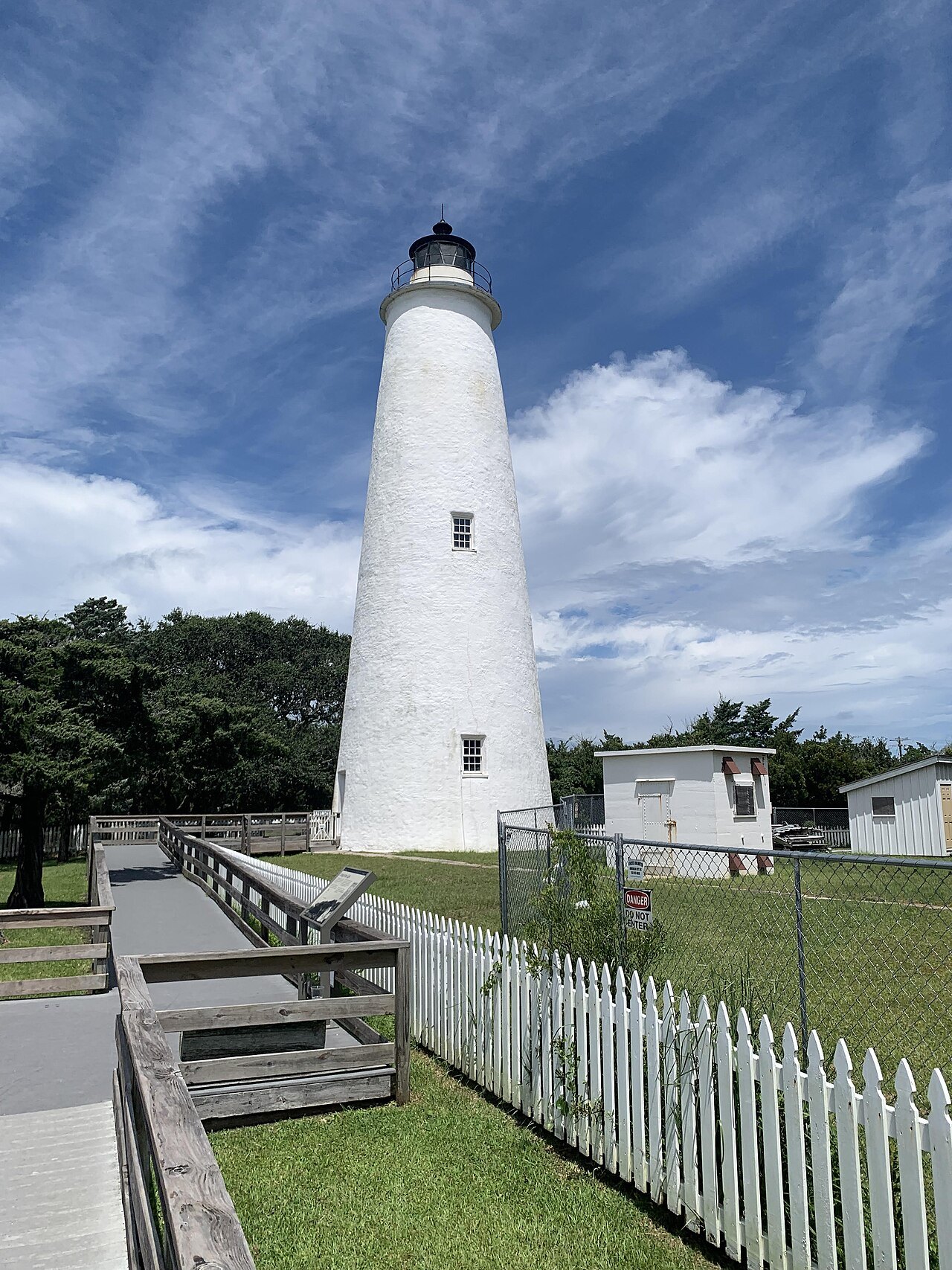The whitewashed Ocracoke Light behind its white picket fence.