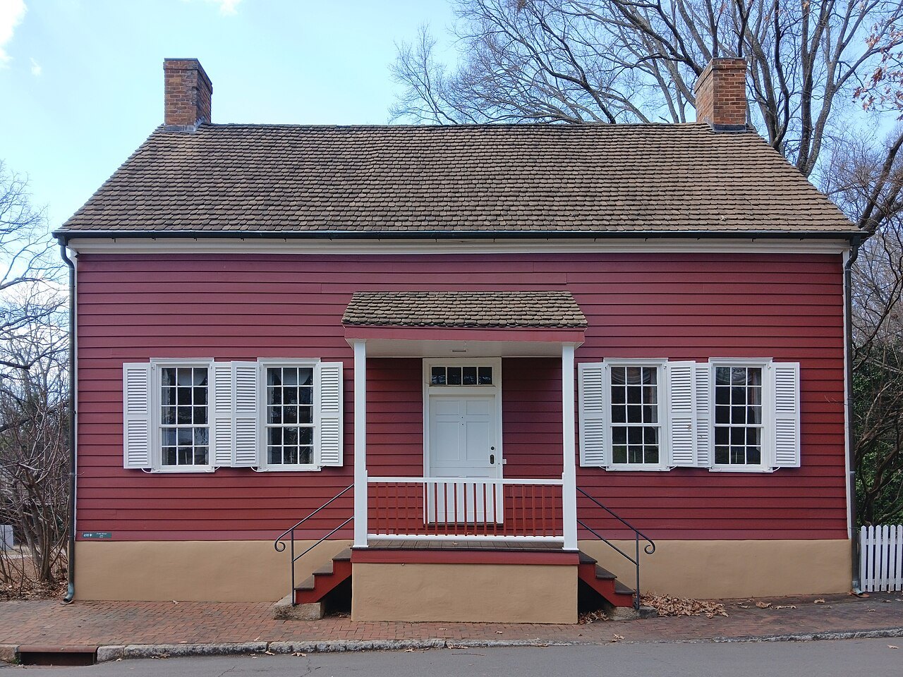 The red clapboard Denke House on a street in Old Salem.