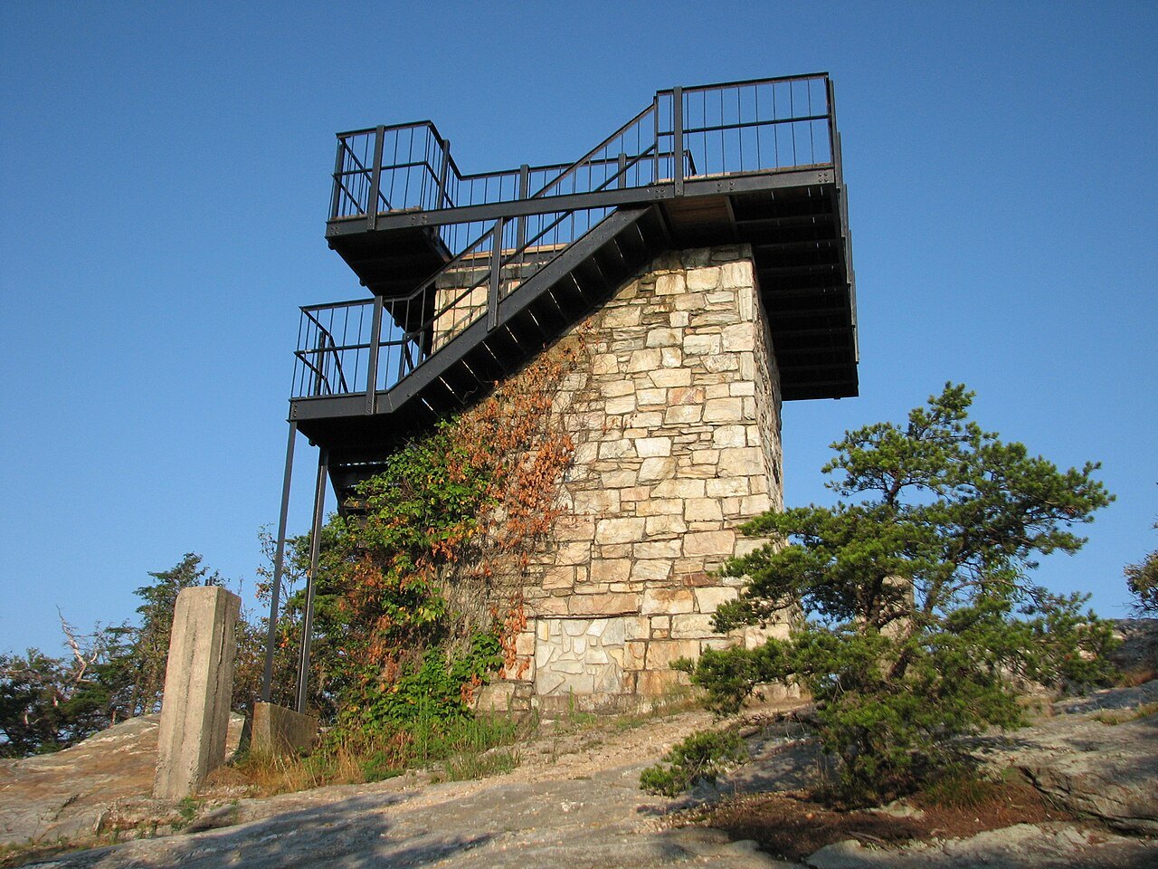 The stone fire tower on Moore's Knob against a blue sky.