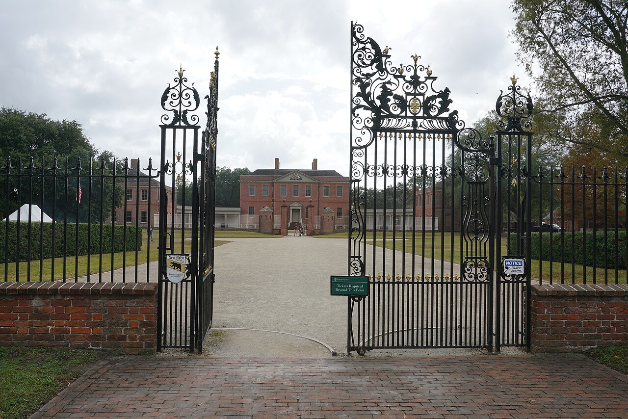 Tryon Palace seen through its open iron gates.