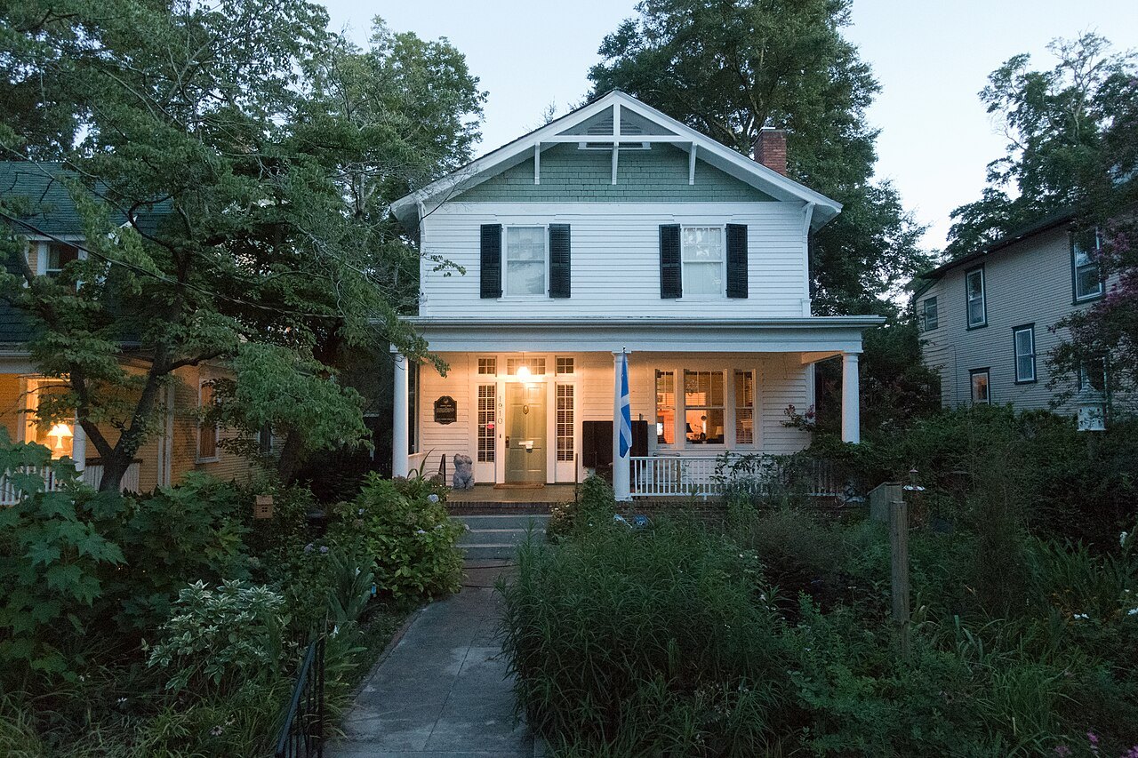 A white house glowing at dusk on Princess Street in Wilmington.