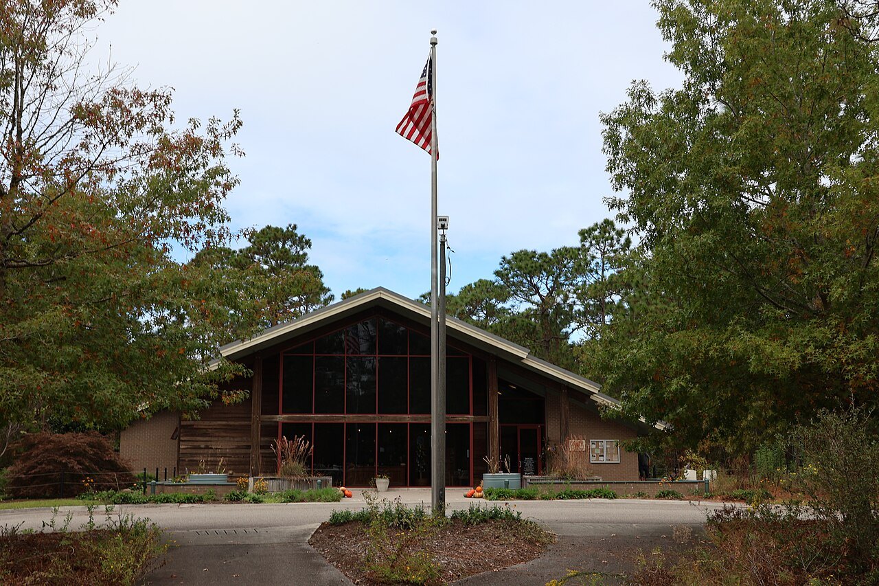 A lodge-style building and flagpole in Halyburton Park, Wilmington.