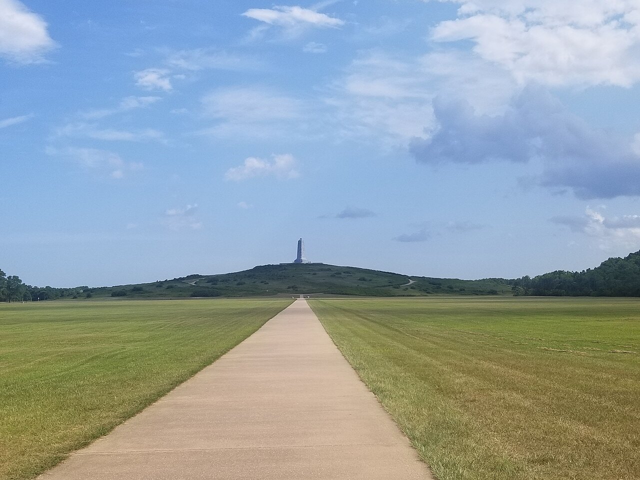 A long path across the grass toward the Wright Brothers Memorial on Kill Devil Hill.